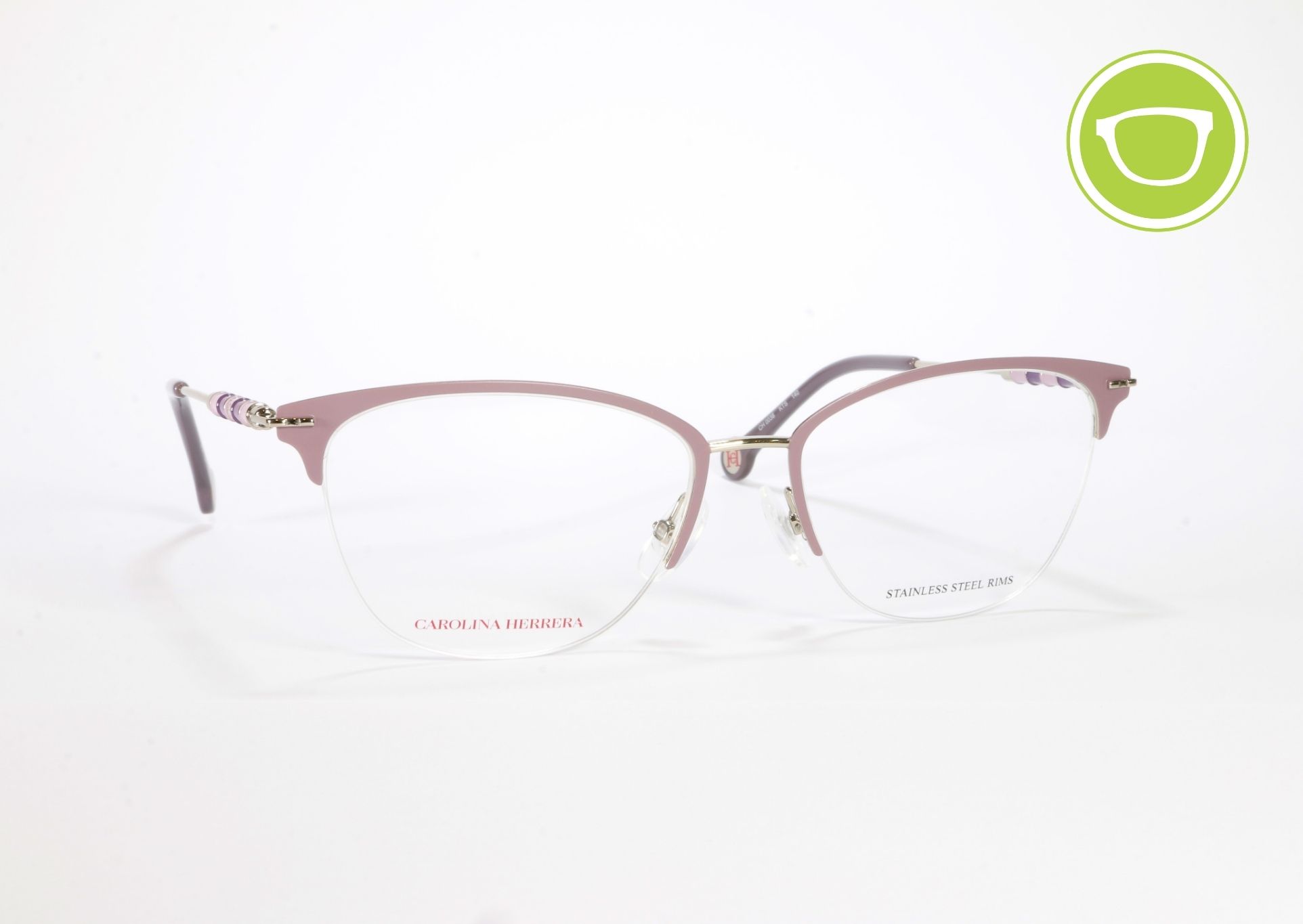 Armazón óptico Carolina Herrera CH0038 para mujer, fabricado en metal ligero color rosado con detalles dorados, diseño elegante y estructura delgada.